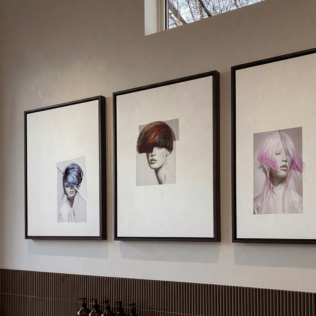 Chevelures 04, 06 and 07 framed prints, black matt floater frames, hung in a row in a hair salon — Beau Edition