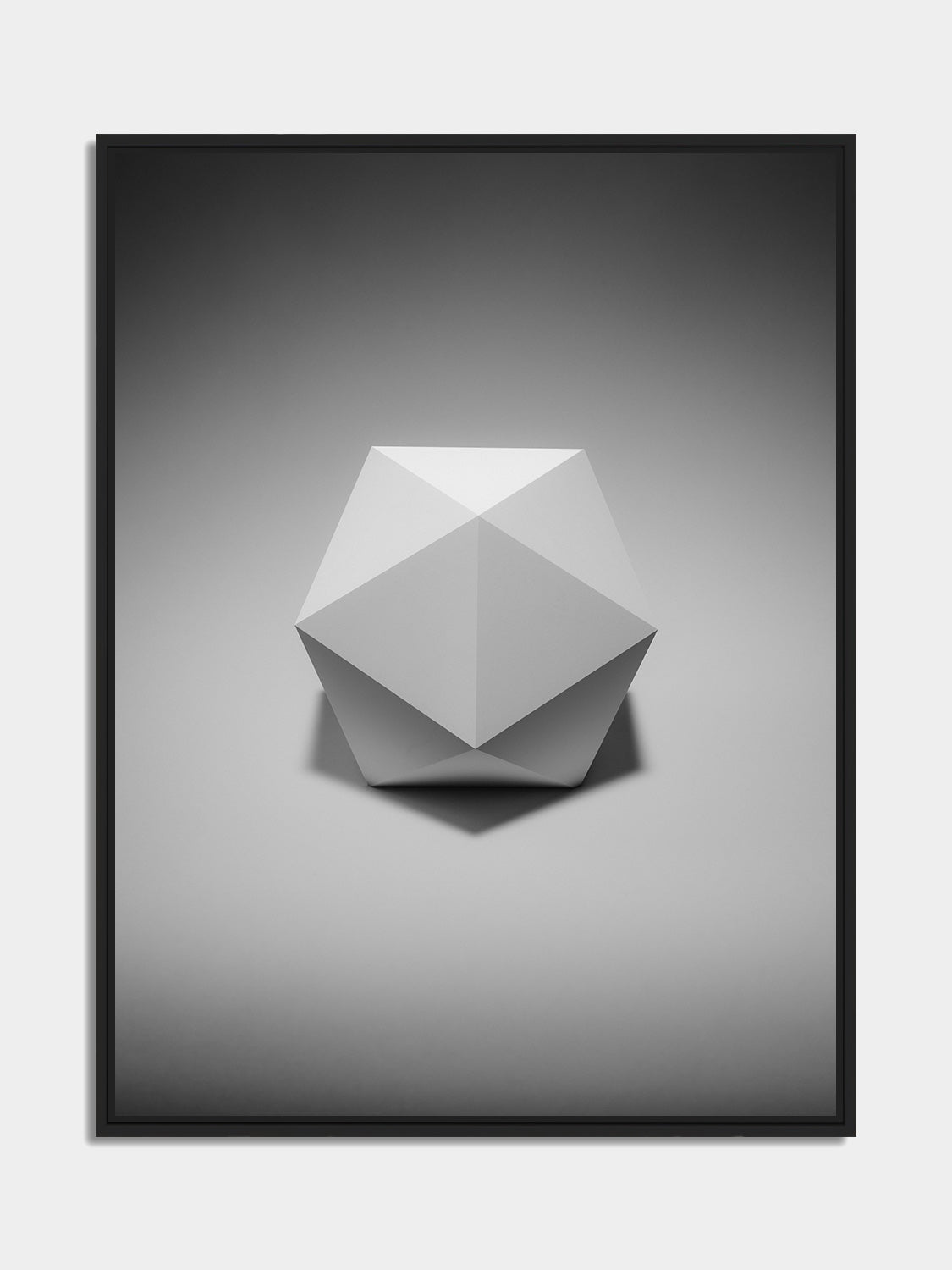 Framed icosahedron print, black matt floater frame, on an office wall — Beau Edition
