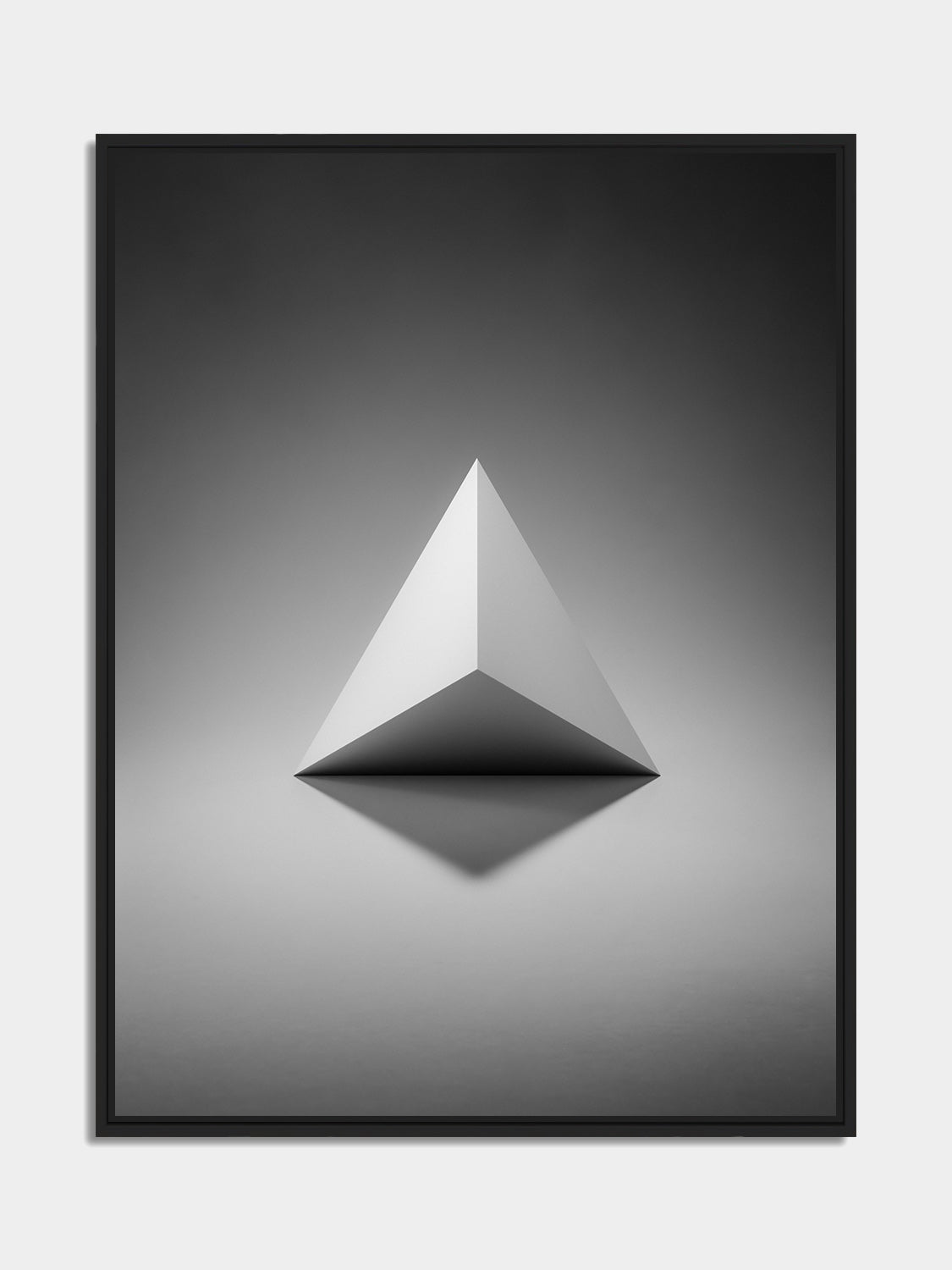 Framed tetrahedron print, black matt floater frame, on an office wall — Beau Edition